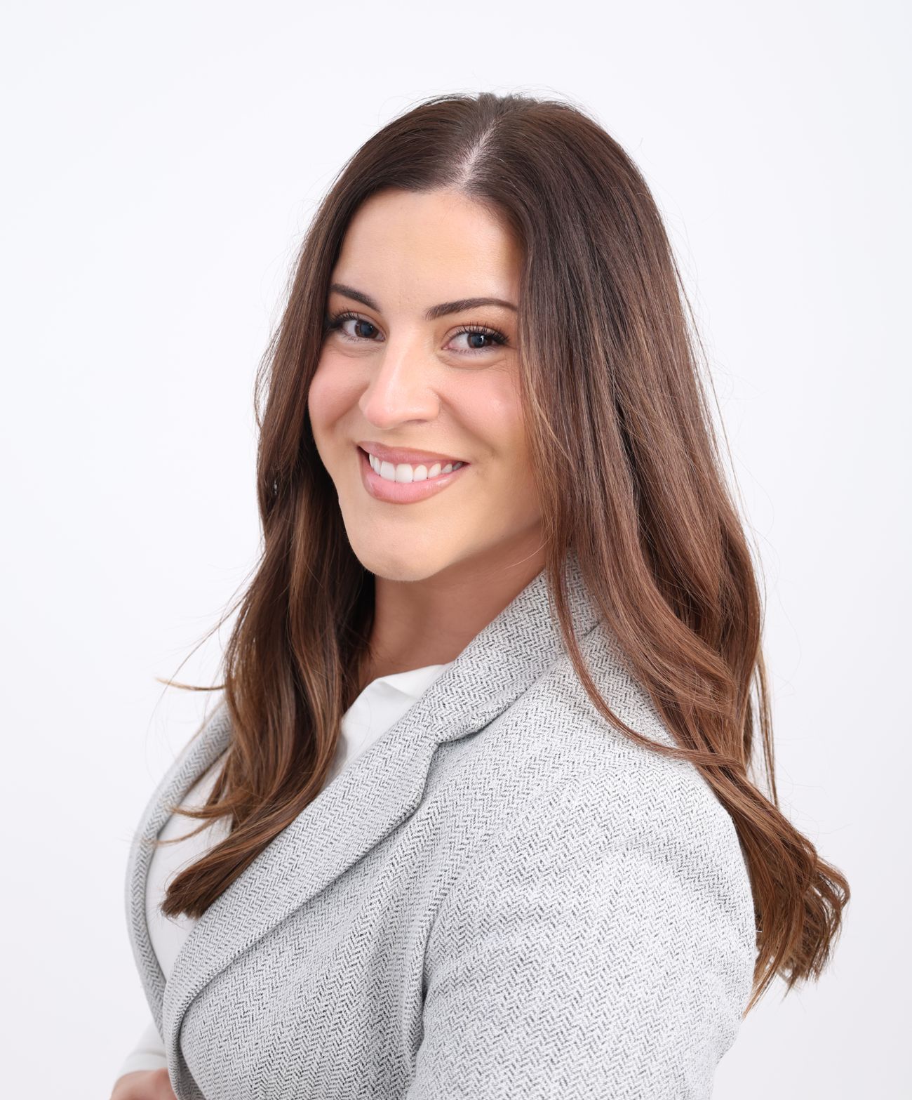 Ivana Kovačević, founder of Heart of Learning, smiling in a grey blazer